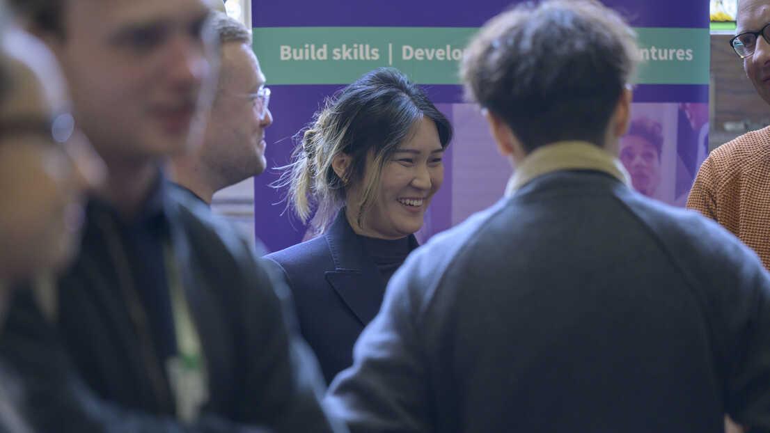 people smiling in room talking