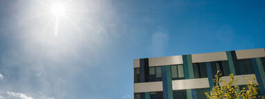 University building with sun shining in background