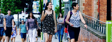 Students and parents walking through campus on a University open day. 