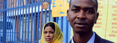 Portrait of a man and a woman outside a car wash