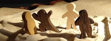 An image of figures in sand