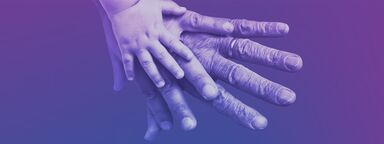 three hands from people in three generations on top of each other.