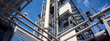 A carbon capture rig featuring a network of intricate pipes across two levels.