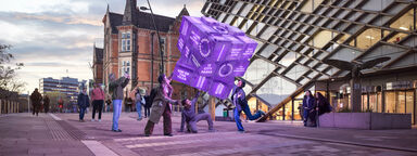 Image shows students interacting with a large purple fortune telling cube outside the Diamond build. The cube features words and phrases like University of the Year, Russell Group and No 1 Students' Union.