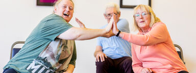 Three people connecting palms together