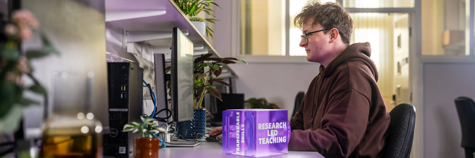 Image shows a student studying in a lab
