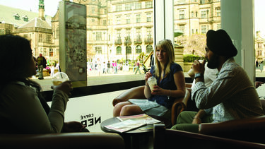 Students drinking coffee at the Peace Gardens
