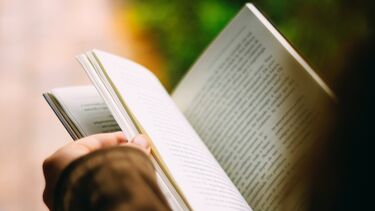 Close-up of person reading a book