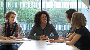 Four students in seminar discussion