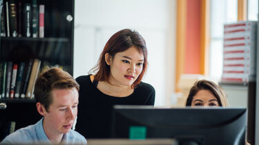 PhD students working together at computer