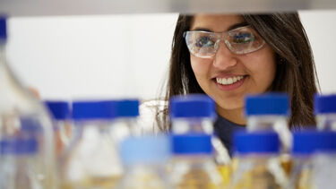 CBE Undergraduate student smiling with bottles 