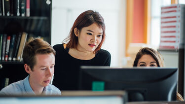 Group of students in front of a computer