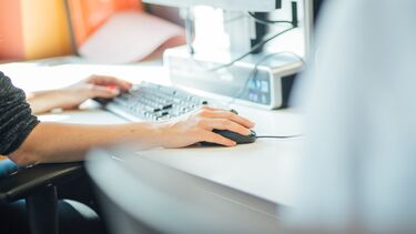 A student working on a computer. 