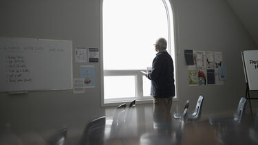 Lonely person looking out of the window
