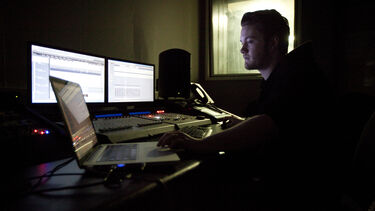 A music technology student in a studio