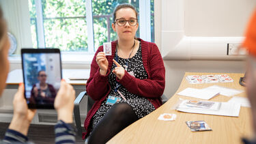 Students training in communication with an iPad.