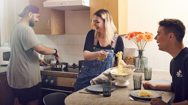 Students in the kitchen making pasta