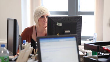 A student sat at a computer - image 