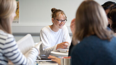 Postgraduate students studying together in the common room