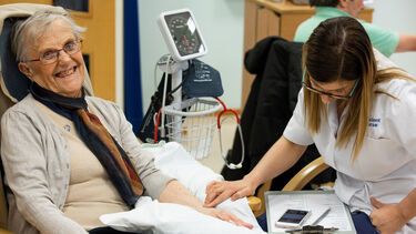 Nursing student examining a happy patient