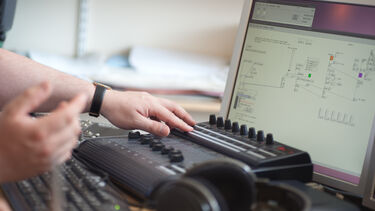 A student using a mixing desk and software