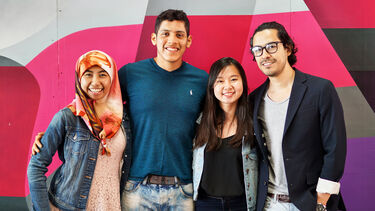 Student ambassadors in front of a colourful background.