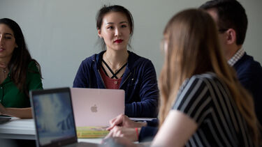 Students sat around desks with laptops