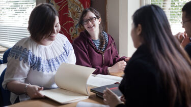 A group of students having a discussion about their work - image 
