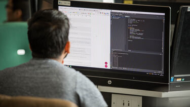 Computer Science student working at a computer