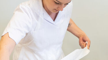 A nurse prepares equipment. 