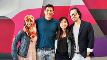 a group of students infront of a brightly coloured wall
