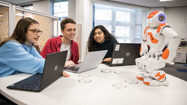 A group of students working with a NAO robot