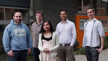 PGR students pose outside the university.