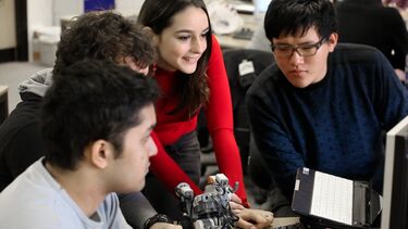 Undergraduate students work on a project.