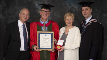 Dr Keith Clarkson receiving the Distinguished Alumni Award