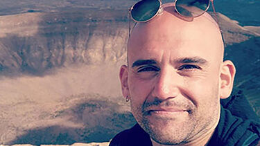 PhD alumni Alfredo posing for the camera. 