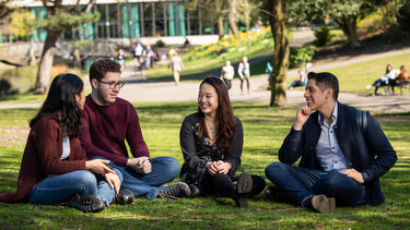 a group of students sat on the grass in Weston Park 