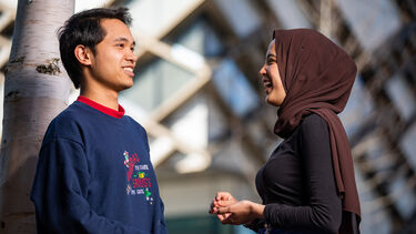 Two student laughing outside the Diamond