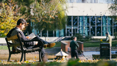 Student reading in Weston Park