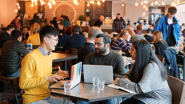 a group of three students sat in Coffee Revolution in the SU