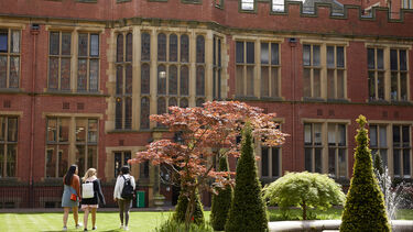 A group of students walking through Firth Court 