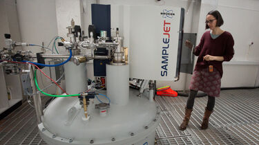 A researcher loads a sample into the 800 MHz spectrometer