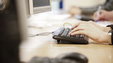 A person typing on a keyboard