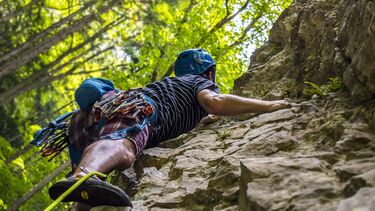 A orienteer climbing a rocky surface