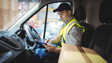 Photo of delivery driver in a van 