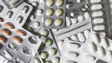 Lots of medication, pills and lozenges, in a pile - image 