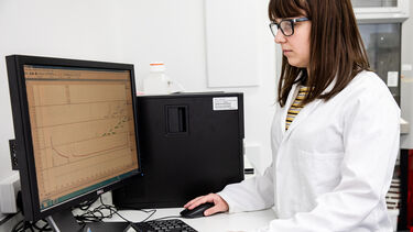 A postgraduate medicine student working on a computer