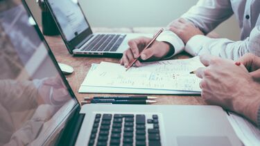 Officer workers at two laptops