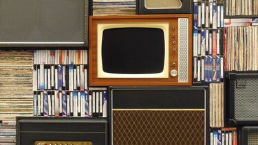 old fashioned TV, speakers, books