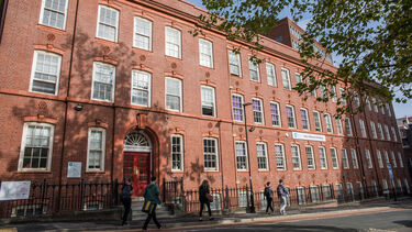 People walking by the Amy Johnson building - image 